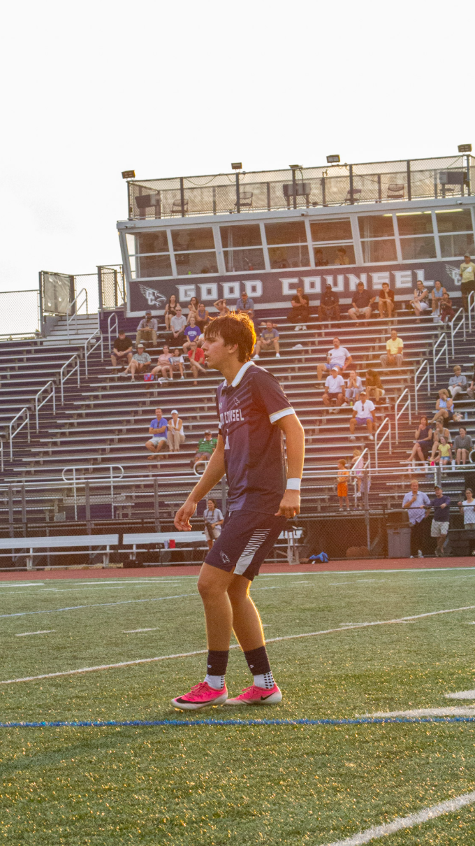 Soccer player in front of the Good Counsel bleachers at golden hour