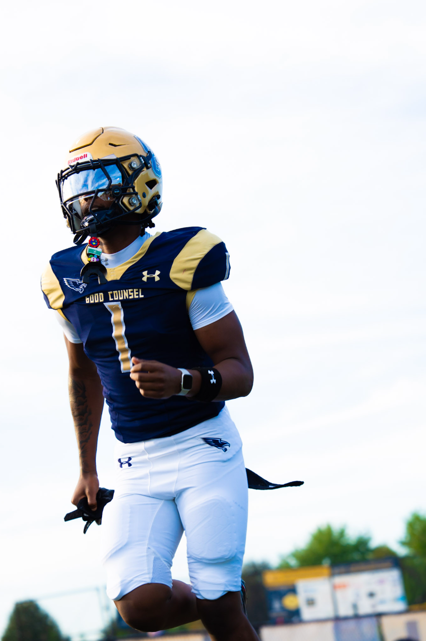 Player number 1 in navy and gold sprinting downfield