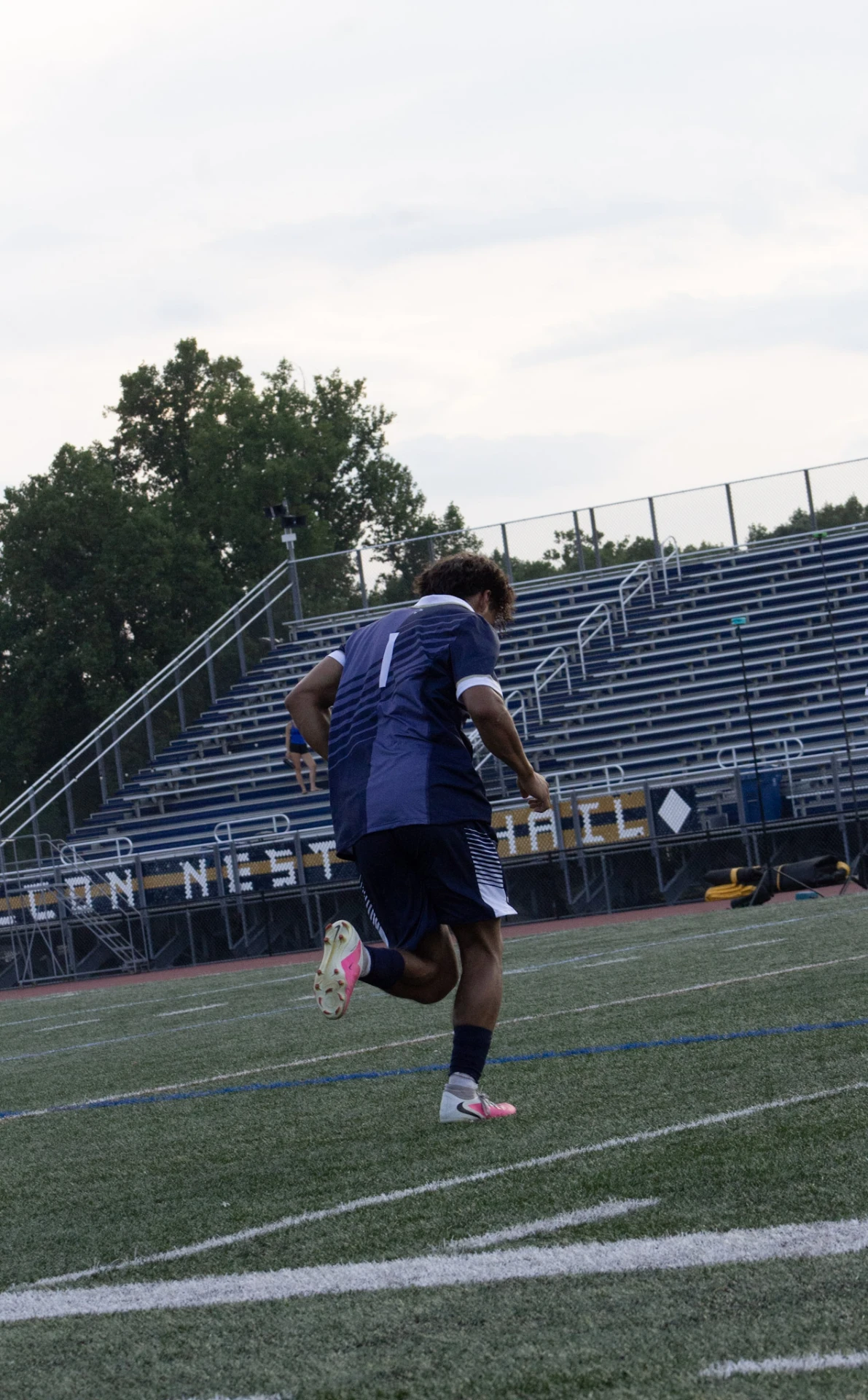 Soccer player number 1 jogging toward the stands